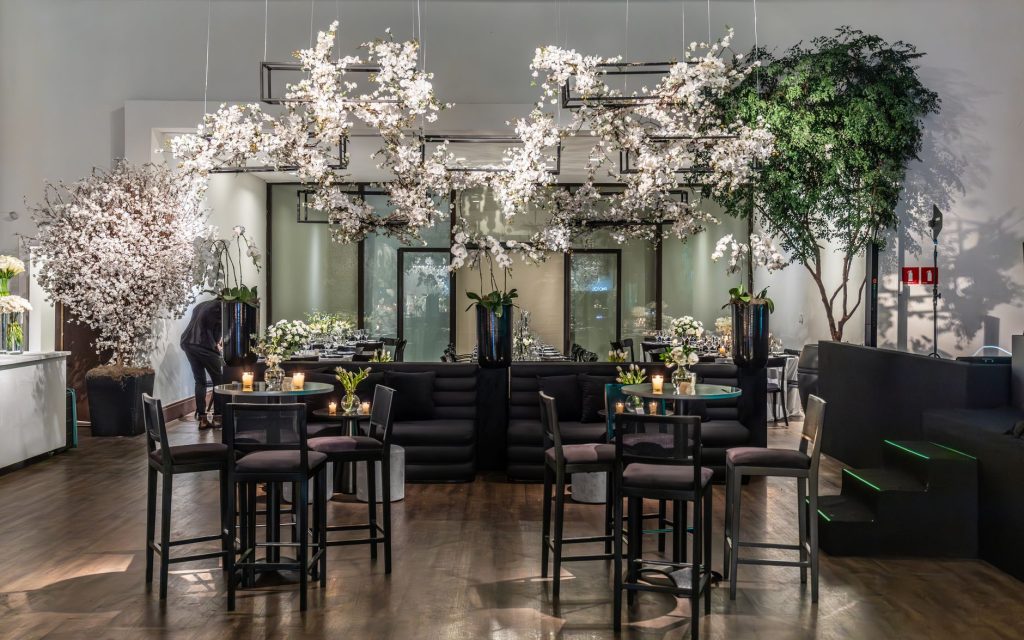 A beautifully decorated indoor venue featuring floral arrangements, soft lighting, and modern furniture. — The Continuum Loca