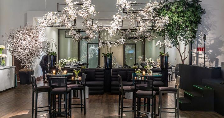 A beautifully decorated indoor venue featuring floral arrangements, soft lighting, and modern furniture. — The Continuum Loca