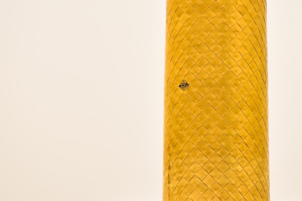 close-up of a cylindrical object with a decorative pattern and a small hole