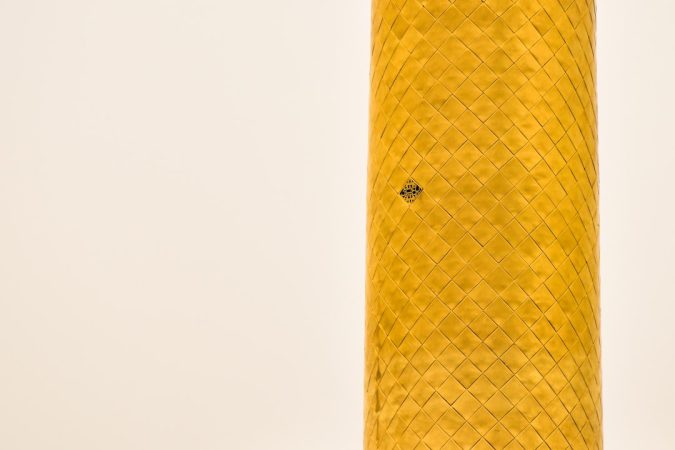 close-up of a cylindrical object with a decorative pattern and a small hole
