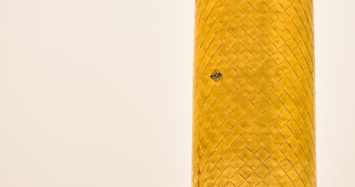 close-up of a cylindrical object with a decorative pattern and a small hole