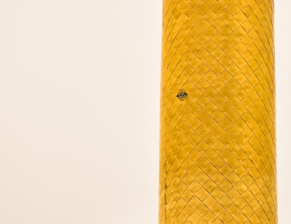 close-up of a cylindrical object with a decorative pattern and a small hole